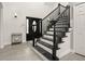 Elegant staircase with black railing and gray flooring at 2393 Appy Ln, Apopka, FL 32712
