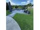 Outdoor fire pit with seating and lush landscaping at 2393 Appy Ln, Apopka, FL 32712