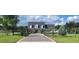 Two-story home with a paved driveway and landscaped yard at 2393 Appy Ln, Apopka, FL 32712