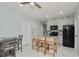Modern kitchen with granite countertops and island seating at 2393 Appy Ln, Apopka, FL 32712