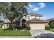 Two-story house with brick facade, attached garage, and manicured lawn at 12986 Maribou Cir, Orlando, FL 32828