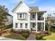 Two-story farmhouse with front porch, brick walkway, and well-manicured lawn at 13168 Lower Harden Ave, Orlando, FL 32827