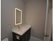 Modern bathroom with illuminated mirror and quartz countertop at 20797 Racine St, Orlando, FL 32833