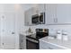 Modern kitchen with stainless steel appliances and grey cabinets at 195 River Front Way, Edgewater, FL 32141