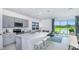 Modern kitchen with grey cabinets, white countertops, and island with seating at 195 River Front Way, Edgewater, FL 32141