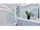 Modern bathroom with a double vanity, a large mirror and a walk-in shower at 195 River Front Way, Edgewater, FL 32141