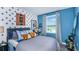Spacious bedroom with blue walls, a comfortable bed, and a workspace at 195 River Front Way, Edgewater, FL 32141