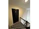 Apartment entryway with black door and patterned rug at 1944 Conway Rd # 6, Orlando, FL 32812