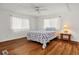 Cozy bedroom featuring wood-look floors and a seashell-themed bedspread at 6 Orangewood Dr, Fruitland Park, FL 34731