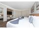 Bedroom with two twin beds, a home office, and a view of the balcony at 6165 Carrier Dr # 1210, Orlando, FL 32819