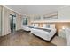 Bright bedroom featuring two beds, hardwood floors, and access to a balcony at 6165 Carrier Dr # 1210, Orlando, FL 32819