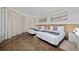 Spacious bedroom with two twin beds, hardwood floors, and large windows at 6165 Carrier Dr # 1210, Orlando, FL 32819
