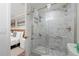 Walk-in shower with marble tile and glass enclosure at 6165 Carrier Dr # 1210, Orlando, FL 32819