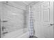 Clean bathroom with a shower/tub combo and marble tile at 1451 Twin Rivers Blvd, Oviedo, FL 32766