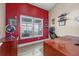 Home office with red walls and wood desk at 1451 Twin Rivers Blvd, Oviedo, FL 32766