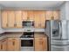 Modern kitchen with stainless steel appliances and wood cabinets at 1563 Reflection Cv, Saint Cloud, FL 34771