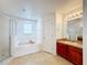 Bathroom includes a garden tub, shower, and vanity at 223 Abbotsbury Dr, Kissimmee, FL 34758