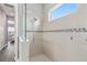 Spa-like bathroom with a large shower and tiled walls at 8632 Bridgeport Bay Cir, Mount Dora, FL 32757