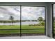 Relaxing screened porch overlooking a tranquil lake at 8632 Bridgeport Bay Cir, Mount Dora, FL 32757