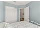 Bedroom with white closet doors and a bed at 8632 Bridgeport Bay Cir, Mount Dora, FL 32757