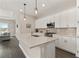 Modern kitchen with white cabinets, granite countertops, and stainless steel appliances at 8632 Bridgeport Bay Cir, Mount Dora, FL 32757