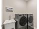 Laundry room with LG washer and dryer, and utility sink at 8632 Bridgeport Bay Cir, Mount Dora, FL 32757