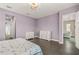 Purple bedroom with double dresser and hardwood floors at 8632 Bridgeport Bay Cir, Mount Dora, FL 32757