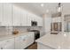 Modern kitchen with white cabinets, granite countertops, and stainless steel appliances at 8632 Bridgeport Bay Cir, Mount Dora, FL 32757