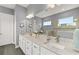 Elegant bathroom with double vanity, granite countertop, and a large shower at 8632 Bridgeport Bay Cir, Mount Dora, FL 32757