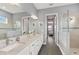 Elegant bathroom with double vanity, granite countertop, and a large shower at 8632 Bridgeport Bay Cir, Mount Dora, FL 32757
