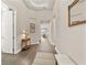 Light-filled hallway with wood-look floors, decorative accents, and access to rooms at 8632 Bridgeport Bay Cir, Mount Dora, FL 32757