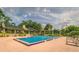 Community pool with plenty of lounge chairs and surrounding landscape at 11 Escondido Cir # 105, Altamonte Springs, FL 32701
