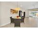 Small dining area with a square table and four wicker chairs at 17349 Serenidad Blvd, Clermont, FL 34714