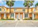 Two-story townhome with columns and palm trees at 17349 Serenidad Blvd, Clermont, FL 34714