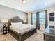 Main bedroom with king-size bed and large windows at 7703 Banyon Way, Kissimmee, FL 34747