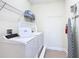 Laundry room with washer, dryer, and shelving at 7703 Banyon Way, Kissimmee, FL 34747