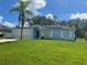 Light blue house with a two-car garage and solar panels at 733 Robin Ct, Kissimmee, FL 34759