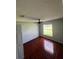 Bright bedroom with wood-look floors and a ceiling fan at 733 Robin Ct, Kissimmee, FL 34759