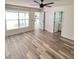 Bright bedroom featuring wood-look floors and ceiling fan at 733 Robin Ct, Kissimmee, FL 34759