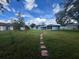 Large backyard with a stone path and screened porch at 733 Robin Ct, Kissimmee, FL 34759
