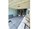 Covered back patio with tiled flooring and access to interior at 733 Robin Ct, Kissimmee, FL 34759