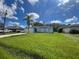 Light blue house with a two-car garage and solar panels at 733 Robin Ct, Kissimmee, FL 34759