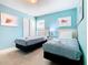 Bedroom with two twin beds and light blue walls at 8844 Corcovado Dr, Kissimmee, FL 34747