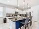 Modern kitchen with white cabinets and large island at 8844 Corcovado Dr, Kissimmee, FL 34747