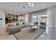 Open living room showcasing a stylish sectional sofa, coffee table, and views into the modern kitchen at 10032 Brocksport Cir, Gotha, FL 34734