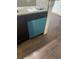 Close-up of teal dishwasher in modern kitchen at 4400 Thornbriar Ln # A202, Orlando, FL 32822
