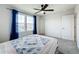 Well-lit bedroom featuring a queen bed and ceiling fan at 5616 Arborvista Dr, St Cloud, FL 34771