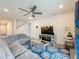 Spacious living room with sectional sofa, ceiling fan, and large TV at 5616 Arborvista Dr, St Cloud, FL 34771