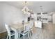 Open dining area with white table and chairs, adjacent to the kitchen at 5616 Arborvista Dr, St Cloud, FL 34771