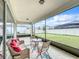 Relaxing screened porch with wicker furniture and backyard view at 5616 Arborvista Dr, St Cloud, FL 34771